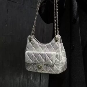 model-holding-chinoiserie-gold-brocade-underarm-bag