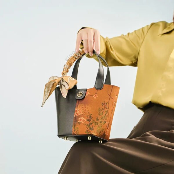 model-seated-plum-blossom-handbag-on-knees model-seated-plum-blossom-handbag-on-knees