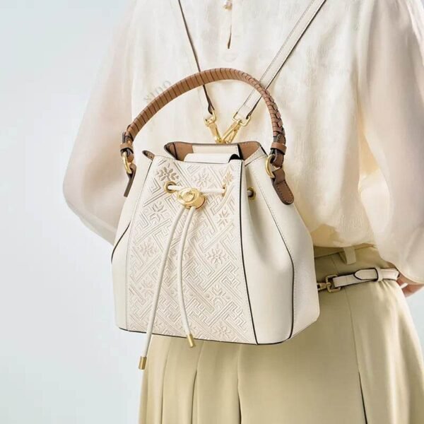 wanj-pattern-embroidered-leather-convertible-backpack-tote-model-wearing-backpack-from-behind wanj-pattern-embroidered-leather-convertible-backpack-tote-model-wearing-backpack-from-behind